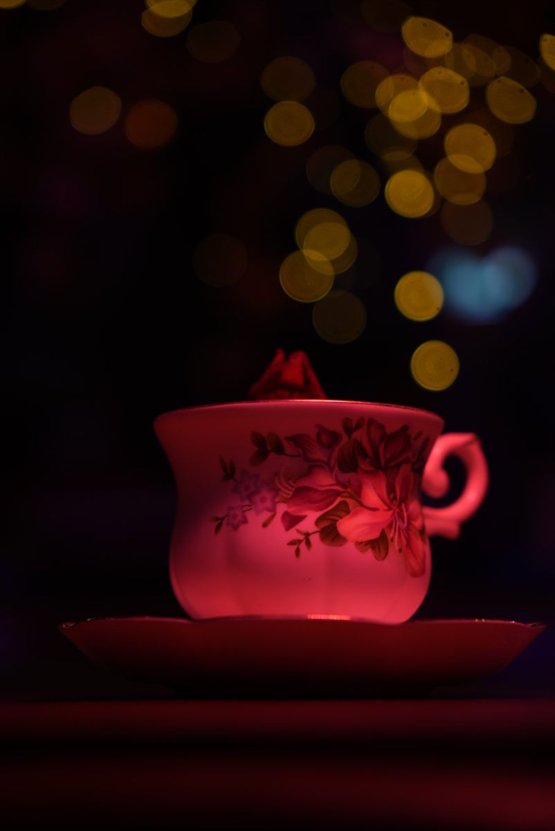 A creamy pink cocktail in an ornate teacup